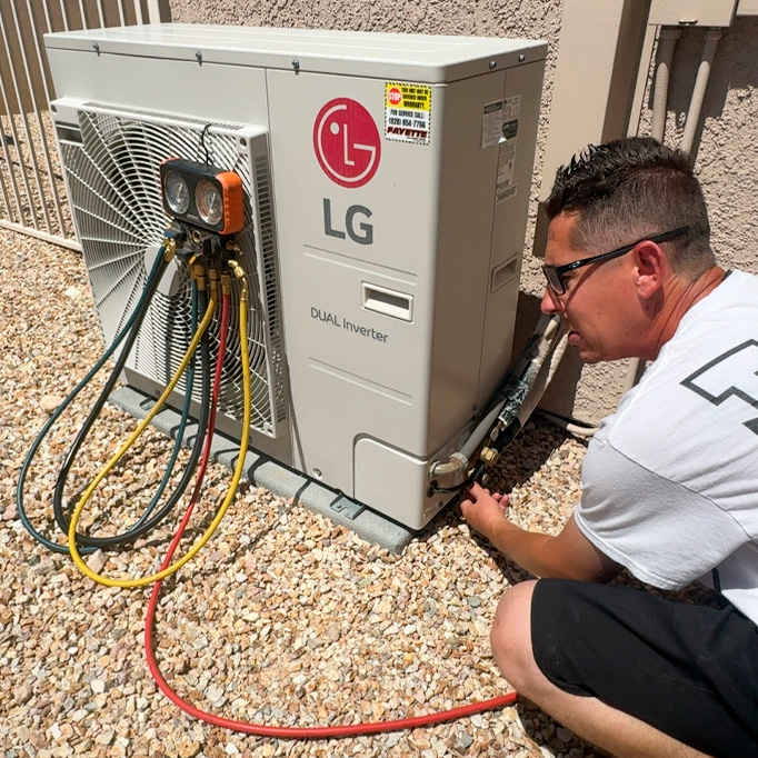 AC repair person checking on a commercial unit
